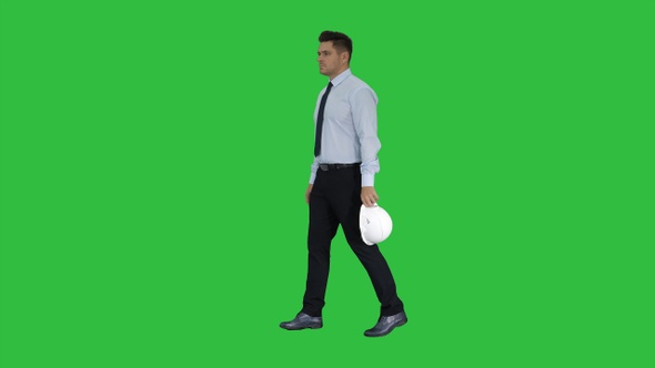 Businessman putting hardhat helmet on Safety on a Green alt