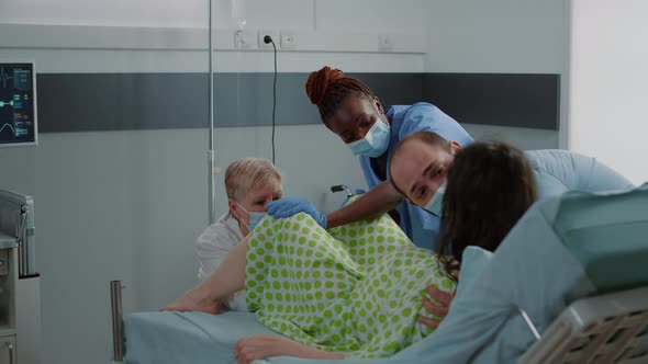 Young Woman Pushing While Giving Birth to Child in Hospital Ward alt