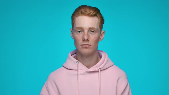 Portrait of Redhead Man Looking at Camera with Poker Face alt