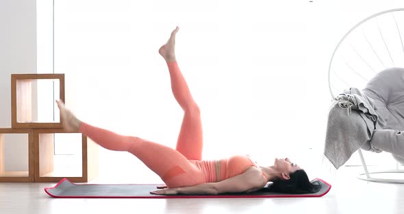 Sporty fit woman is doing abdominal exercises. alt