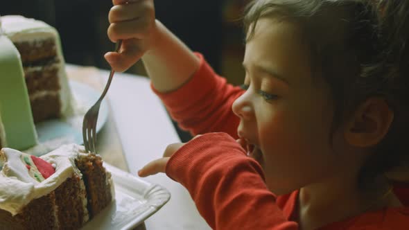The Girl Tasted the Christmas Cake with Gingerbread Cookies in the Shape of Santa Claus alt
