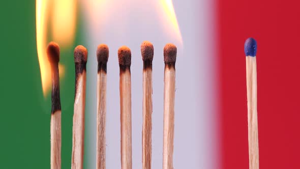 Stay at home, stop Coronavirus epidemic. Burning matches on Italy flag background.