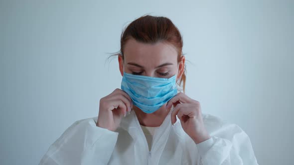 Medical Workers Put on Protective Suit To Work with Sick Patients with a Virus or Infection During alt