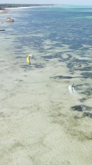 Vertical Video Kitesurfing Near the Shore of Zanzibar Tanzania alt