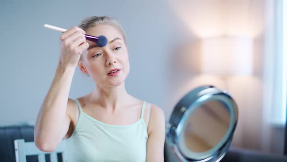 Young Woman Beauty Blogger Shows How to Apply Makeup on Face Makes a Stream on Social Networks alt