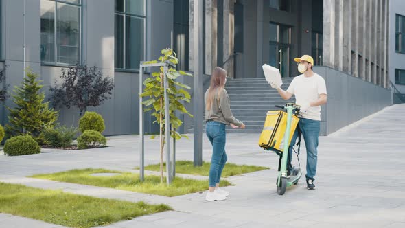 Girl Picks Up Delivery Box From Delivery Rider with Scooter in Front House for alt