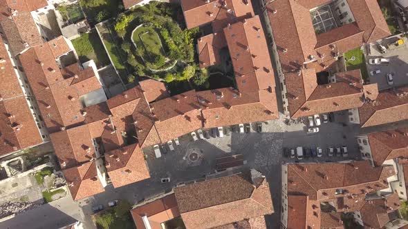 Top down aerial view of a small historic town Venzone in Northern Italy with red tiled roofs alt