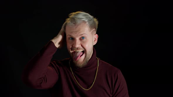 Comical Stupid Stylish Man Making Funny Silly Face Grimace Playing Fool Showing Tongue Brainless alt