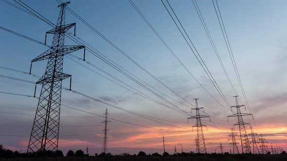 Large Pylons Of Power Lines Against The Background Of An Orange Sunset, Time Lapse, 4k