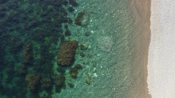 Aerial View on Calm Azure Sea and Volcanic Rocky Shores alt