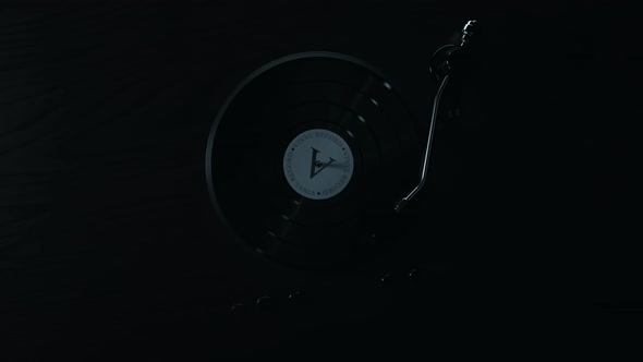 Record player with spinning vintage vinyl playing music, Emerging from dark alt