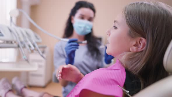 Frightened Scared Caucasian Girl Turning Looking at Camera Covering Mouth with Hand Shaking Head No alt
