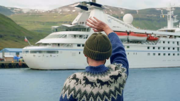 Sailor or Fisherman Wave To Cruise Ship in Fjord alt