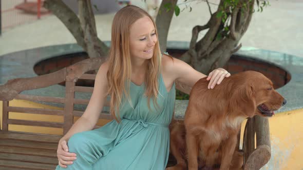Young Woman Visits a Dog Farm, Where You Can Hang Out with Lots of Cute and Adorable Dogs alt