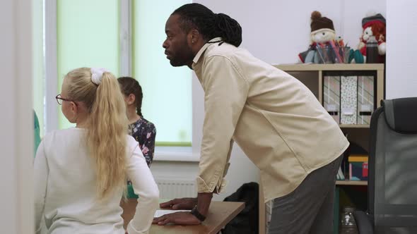 African American Teacher and Group of Children During a Lesson in the Classroom alt