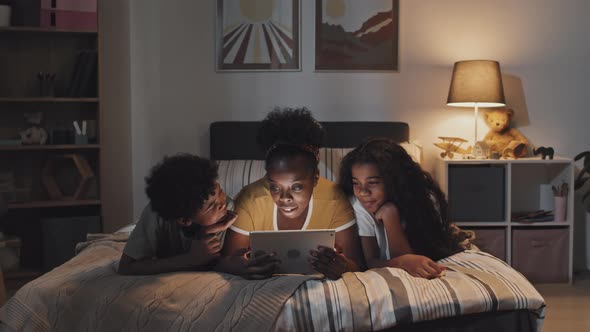 Young Aunt with Kids in Bed, Stock Footage | VideoHive