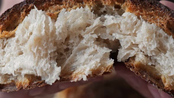 Hands Squeezing Fresh Homemade and Organic Bread Loaf alt