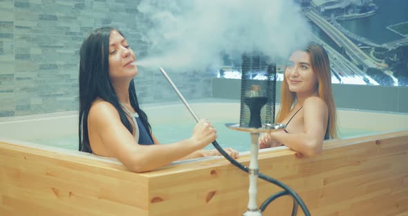 Beautiful and Sexy Girls Smoke Hookah in the Jacuzzi alt