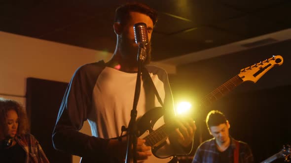 Band performing in studio alt