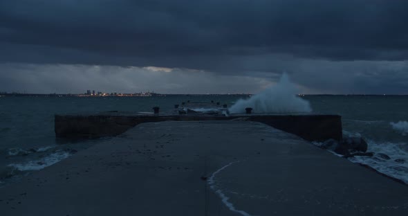 Storm Waves Breaking to Pier at Night alt