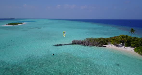 Tropical fly over travel shot of a white sand paradise beach and blue sea background in high resolut alt
