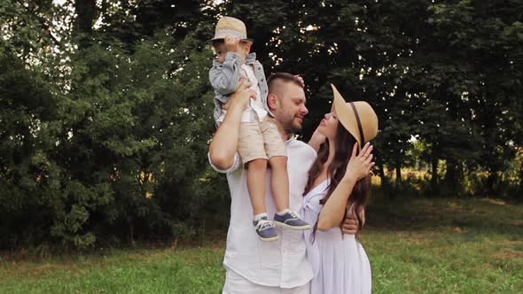 Family Standing in Green Park.