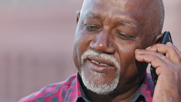 Smiling Older Black Man Talking on Cellphone Closeup Happy Grandfather Chatting with Relatives or alt