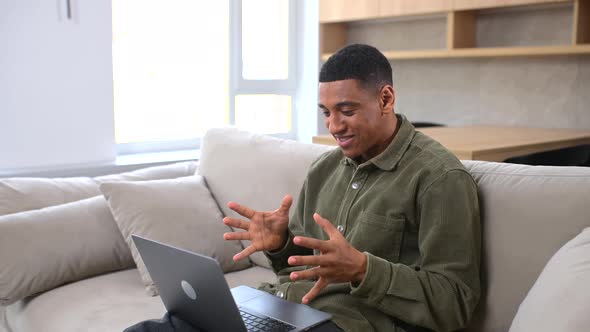 Cheerful Carefree Guy Using Laptop Computer for Video Connection