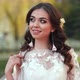 The Bride in a White Dress Shows Beautiful Makeup on Her Face in the Street - VideoHive Item for Sale