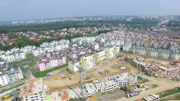 Building Materials and Equipment are Located on the Site of the Construction of Modern High Rises alt