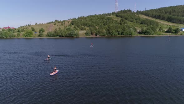 Aerial view of people Stand Up Paddling on pond in provincial city 23 alt