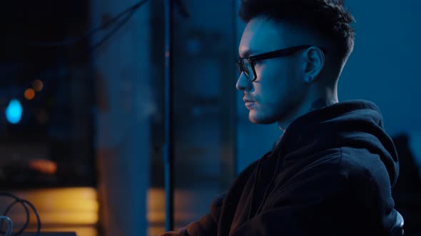 Hacker Using Computer for Cyber Attack at Night 9 alt