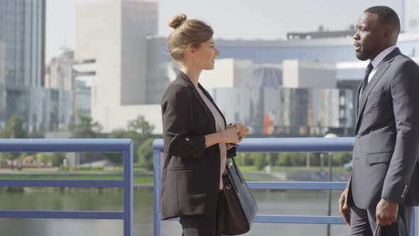 Business Couple Talking Outdoors In City Centre alt