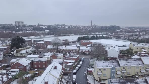 Ascending drone shot of a snowy Exeter looking towards the town centre alt