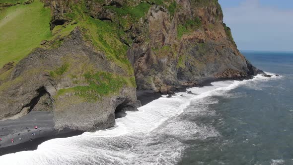 Basalt columns and a cave at Reynisfjara black sand beach in Iceland alt