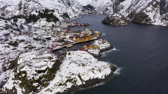 Nusfjord Village and Mountains in Winter. Lofoten Islands, Norway. Aerial View alt