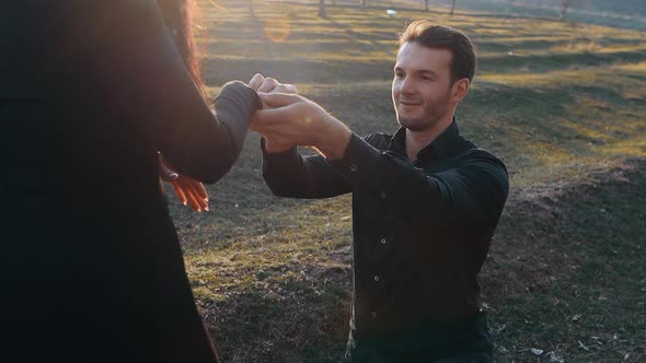 The Young Man in Love Proposes Marriage to His Beloved Woman After Which He Puts the Ring on His alt