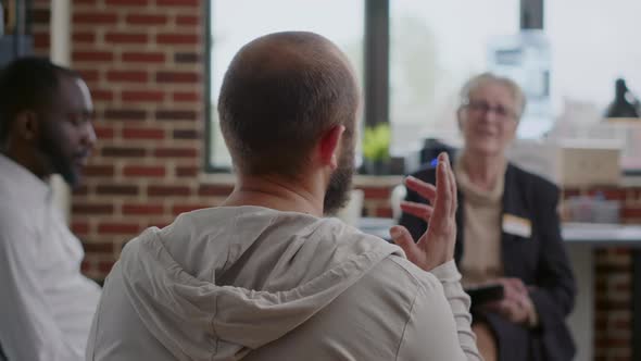 Close Up of Man Complaining About Mental Health Problems at Aa Group Meeting alt