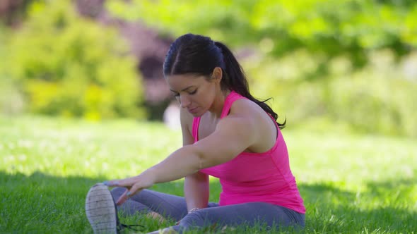 Athletic woman at park stretching before run