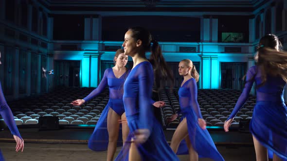 Group Young Skillful Ballerinas Dancing Modern Ballet on the Stage of Large Hall. Girls Looking at alt