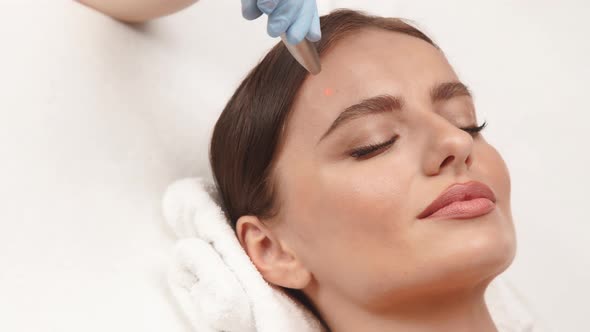 Pretty Woman Face and Erbium Laser Working on It alt