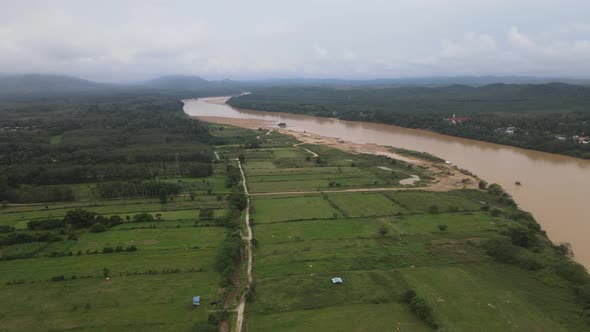 Aerial view of river, forest and fishing boat in Kelantan