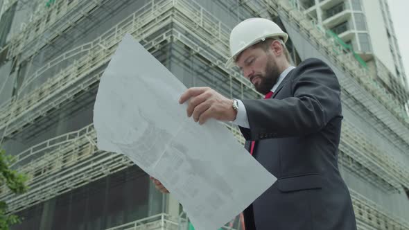 Portrait of a Professional Heavy Caucasian Engineer Worker Wearing Safety Uniform and Hard Hat alt