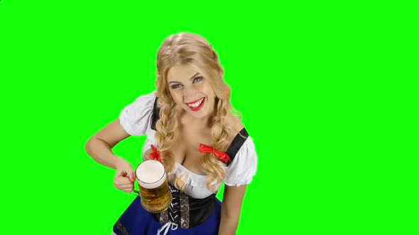 Girl in Bavarian Costume Drinking Beer From the Glass and Licked. Green Screen alt