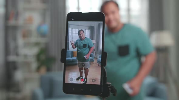 Man Shoots Video Content For Social Networks And Shows Focus On The Smartphone, Magician With Cards alt