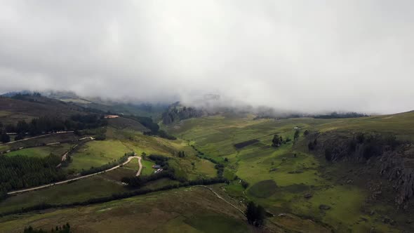 Green Terrain Of The Hills Under White Cloudy Sky In Cumbemayo In Peru. aerial alt