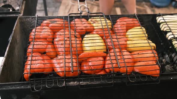Bell Peppers and Vegetables are Grilled on Grid in Open Barbecue at Food Court alt