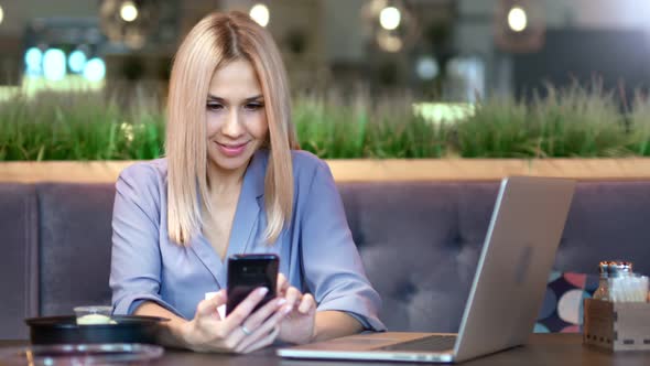 Portrait of Happy Smiling Young Female Businesswoman Typing Message or Chatting Using Smartphone alt