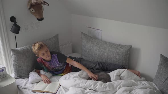 Boy reading on bed