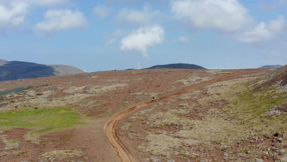 Birds Eye View of Man Doing Motocross on Desert Greenland in Iceland alt